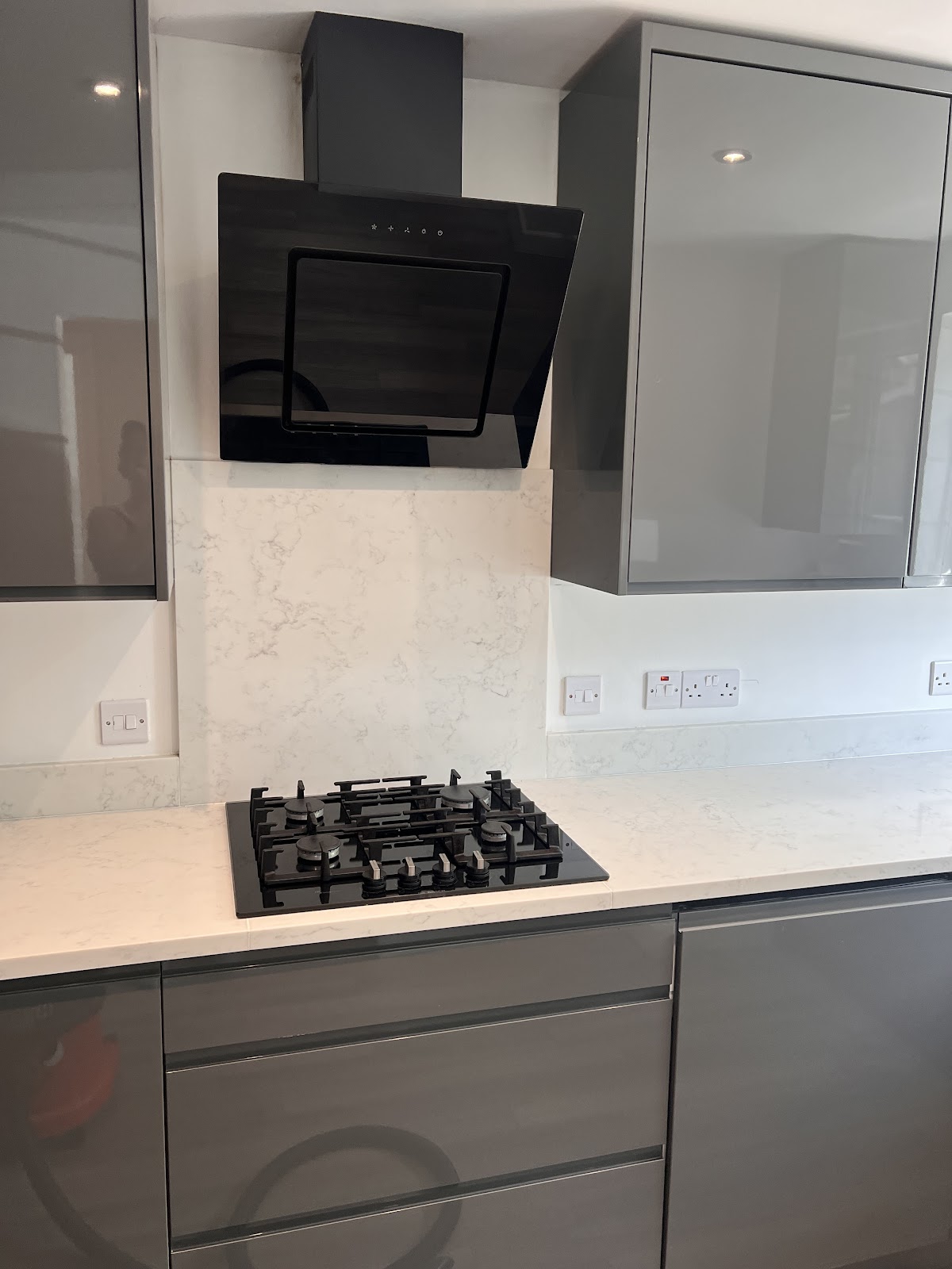 Spotless modern grey kitchen with marble splashback