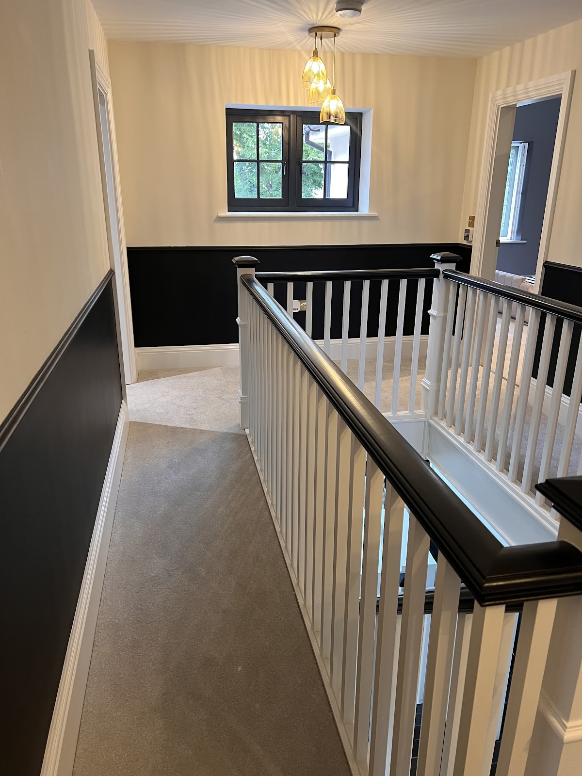 Clean landing and staircase with immaculate carpet