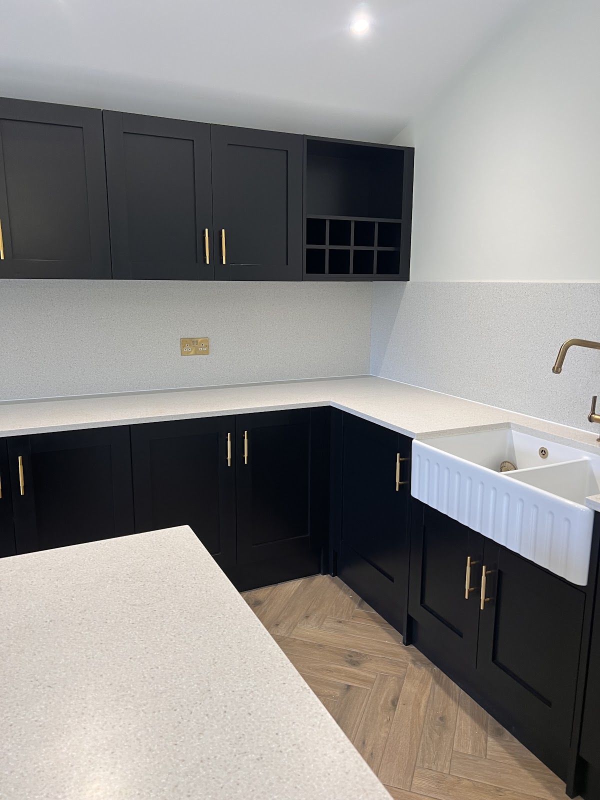 Sparkling black shaker utility room with Belfast sink